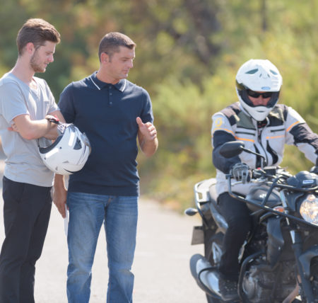 driver instructor controls motorbike pilot